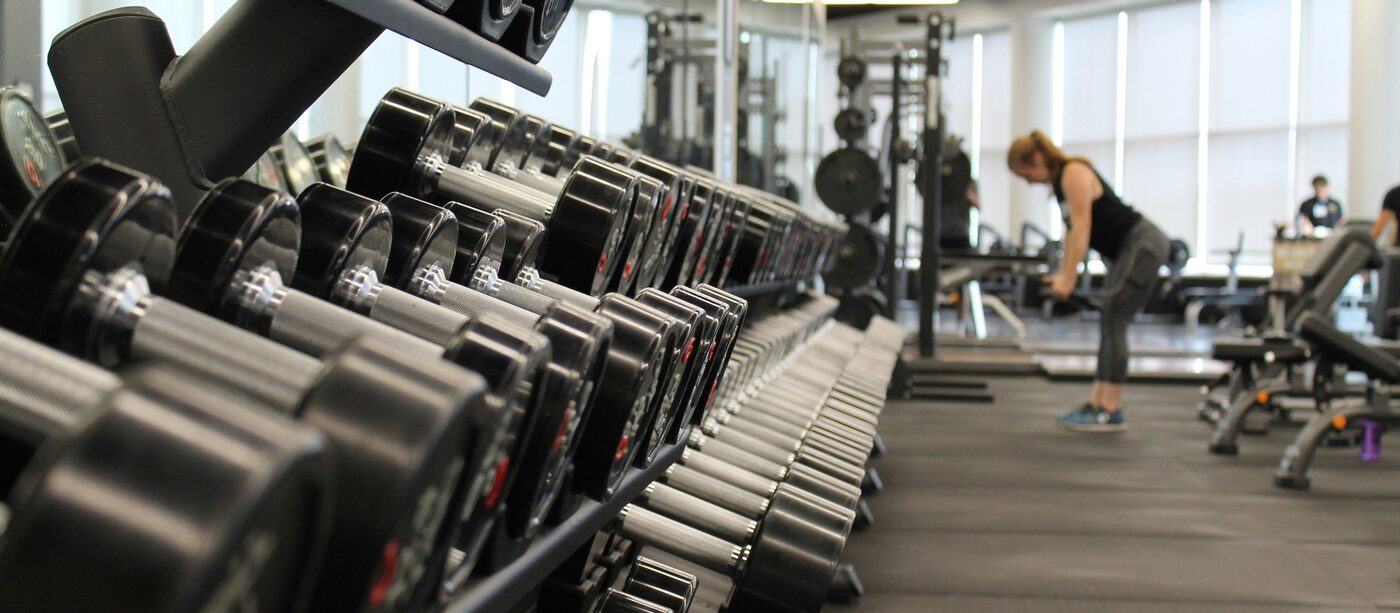 A rack of dumbbells on a gym floor
